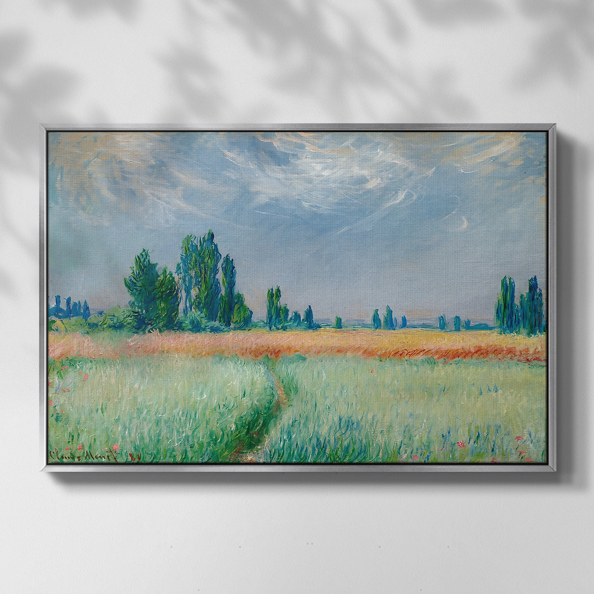 Front view of The Wheat Field (Champ de Blé), 1881 by Claude Monet in a silver floater framed canvas.