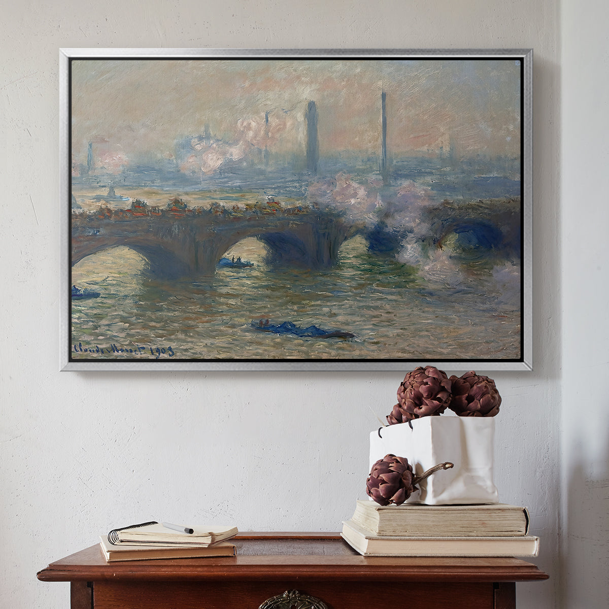 Silver floater framed canvas featuring Waterloo Bridge, Gray Day, 1903 by Claude Monet above an entryway table in a minimalist foyer.