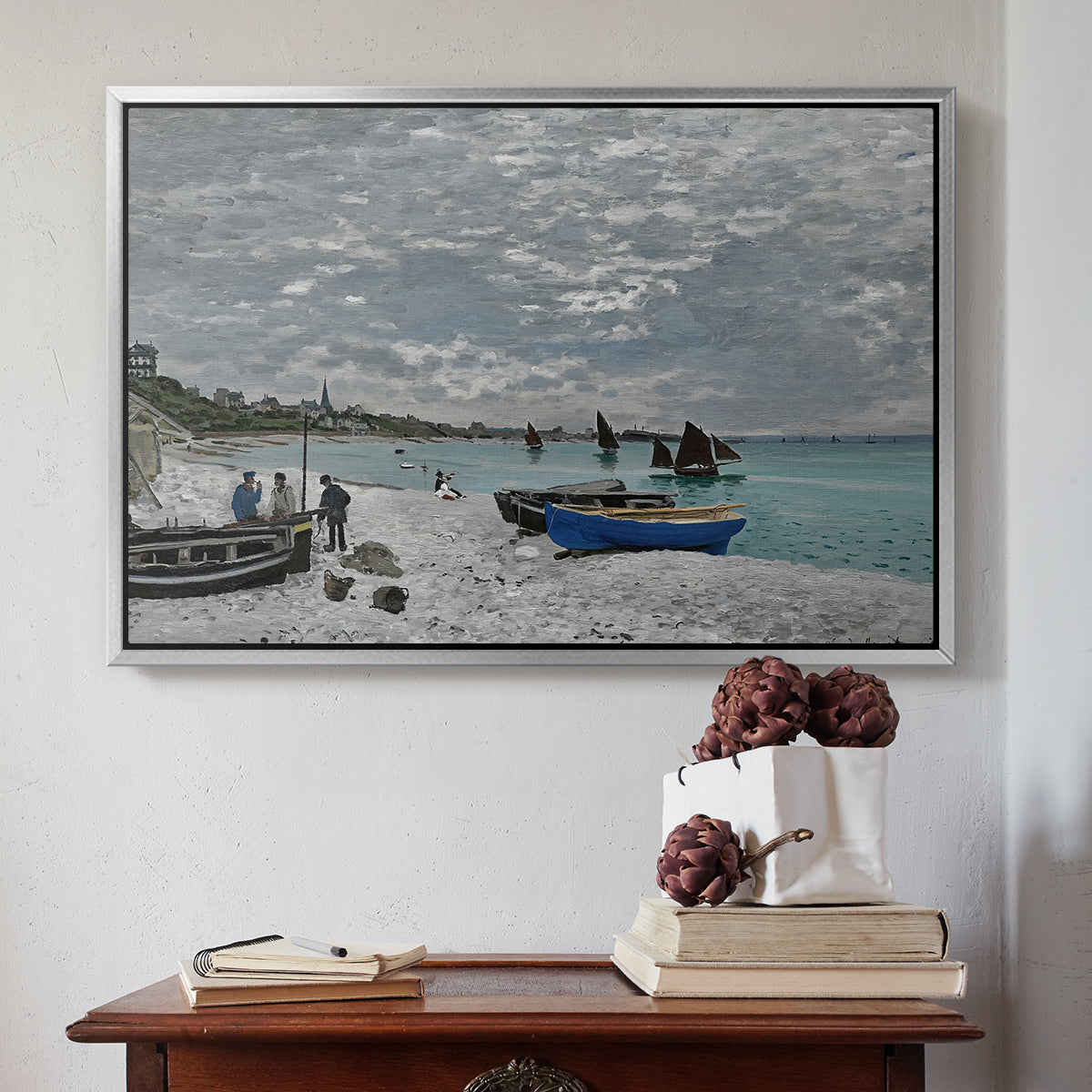 Silver floater framed canvas featuring The Beach at Sainte-Adresse, 1867 by Claude Monet above an entryway table in a minimalist foyer.