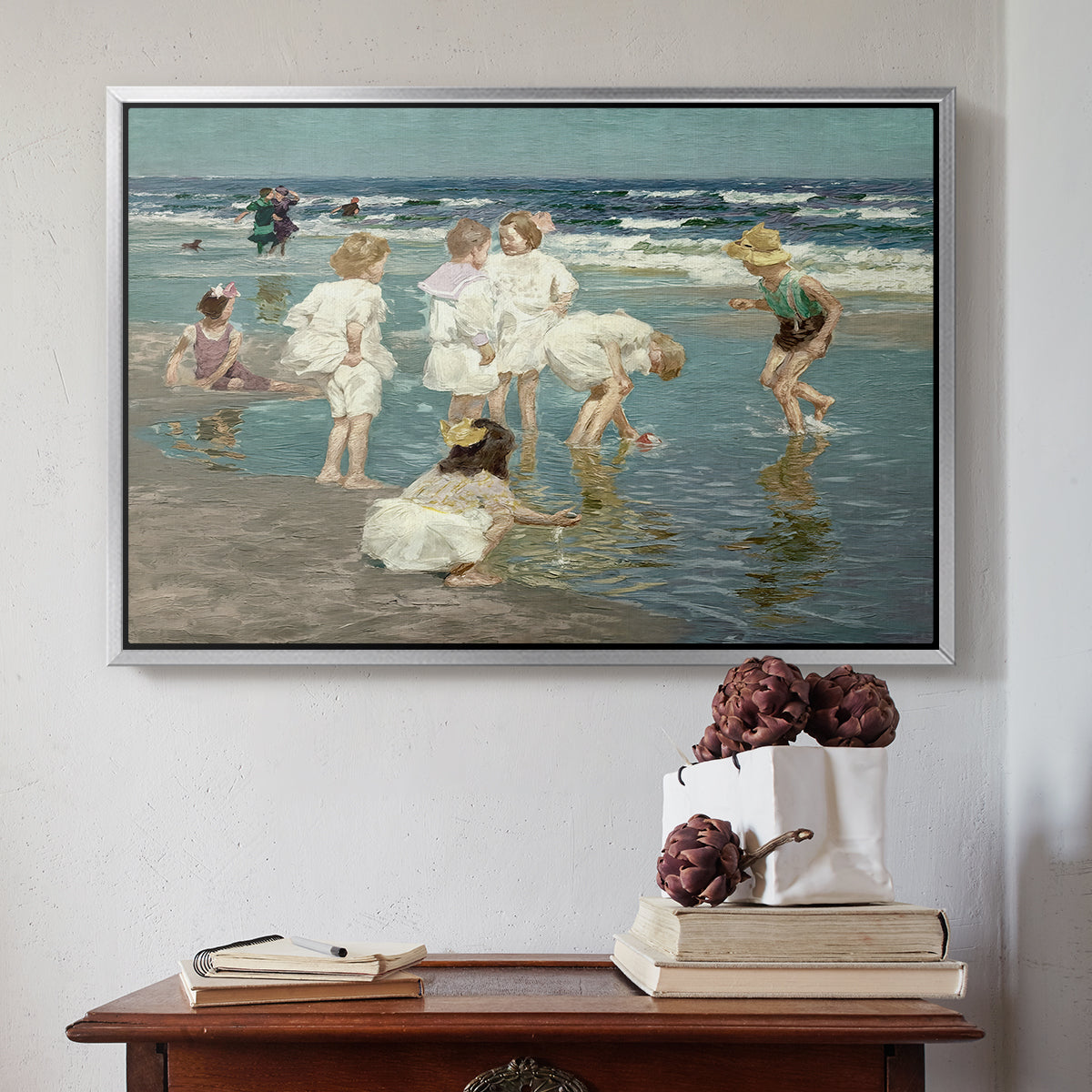 Silver floater framed canvas featuring A Holiday, c. 1915 by Edward Henry Potthast above an entryway table in a minimalist foyer.