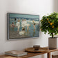 A Holiday, c. 1915 by Edward Henry Potthast, presented in a silver floater framed canvas featuring people relaxing and wading in shallow ocean water along a sunny beach, displayed above a hallway console table.