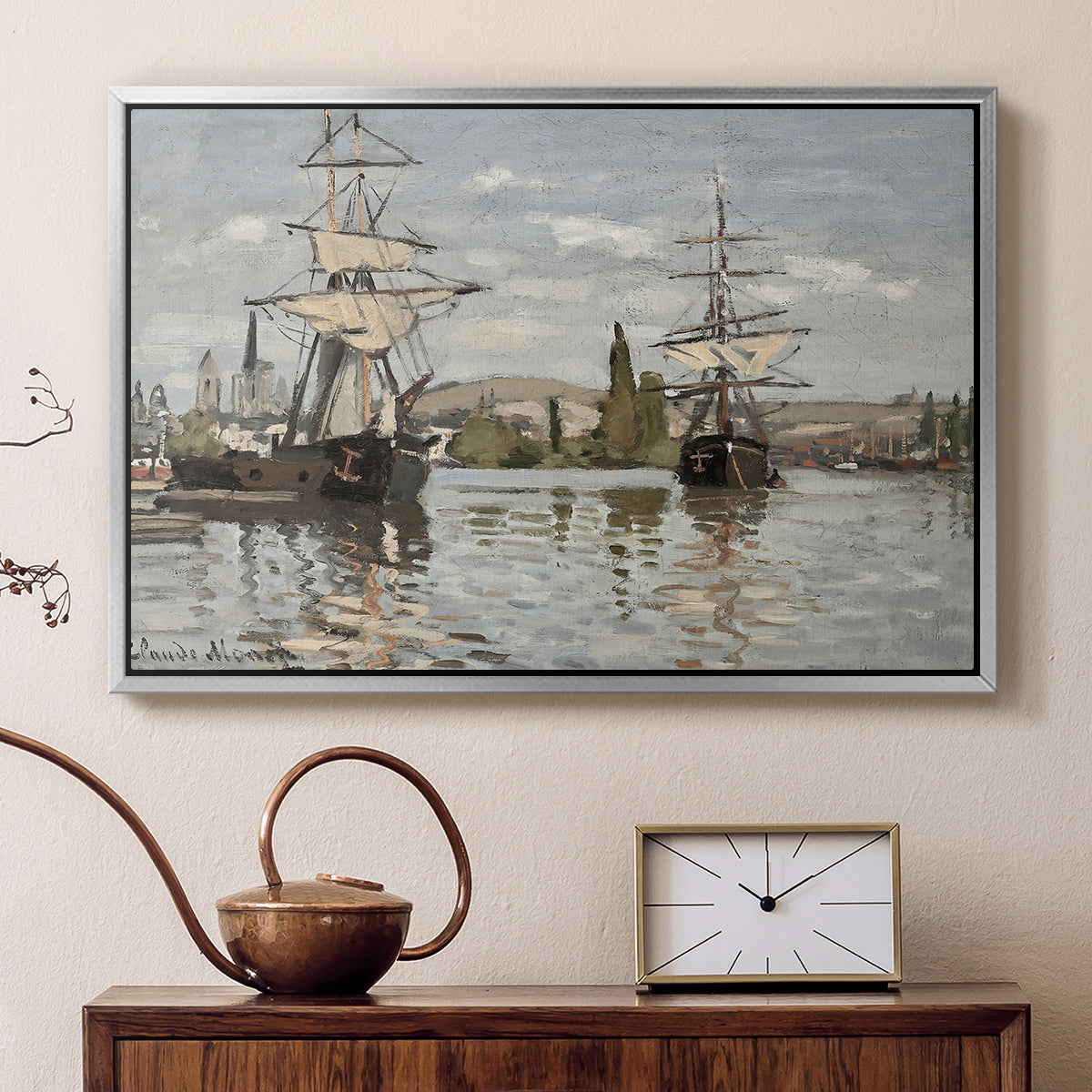 Silver floater framed canvas featuring a harbor view with tall ships lining the waterfront in muted tones, displayed above a cabinet in a soft-toned living room.