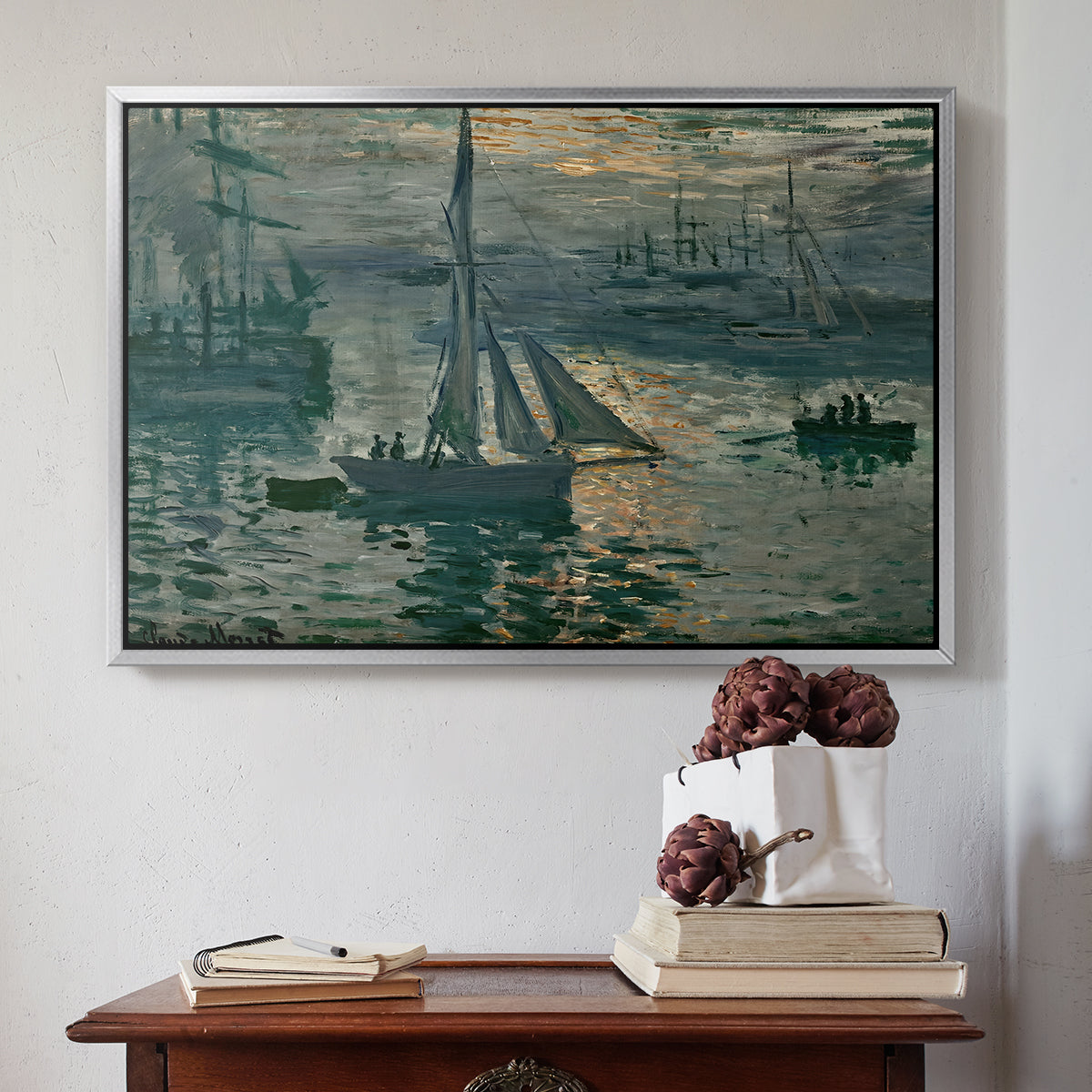 Silver floater framed canvas featuring Sunrise (Marine), 1873 by Claude Monet above an entryway table in a minimalist foyer.
