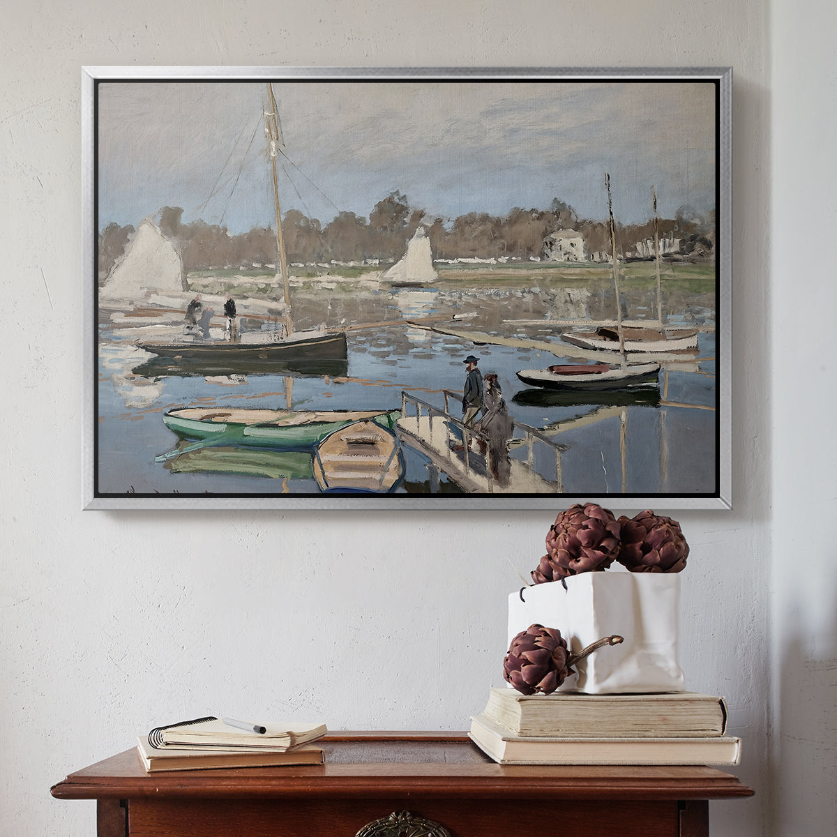 Silver floater framed canvas featuring The Basin at Argenteuil, 1874 by Claude Monet above an entryway table in a minimalist foyer.