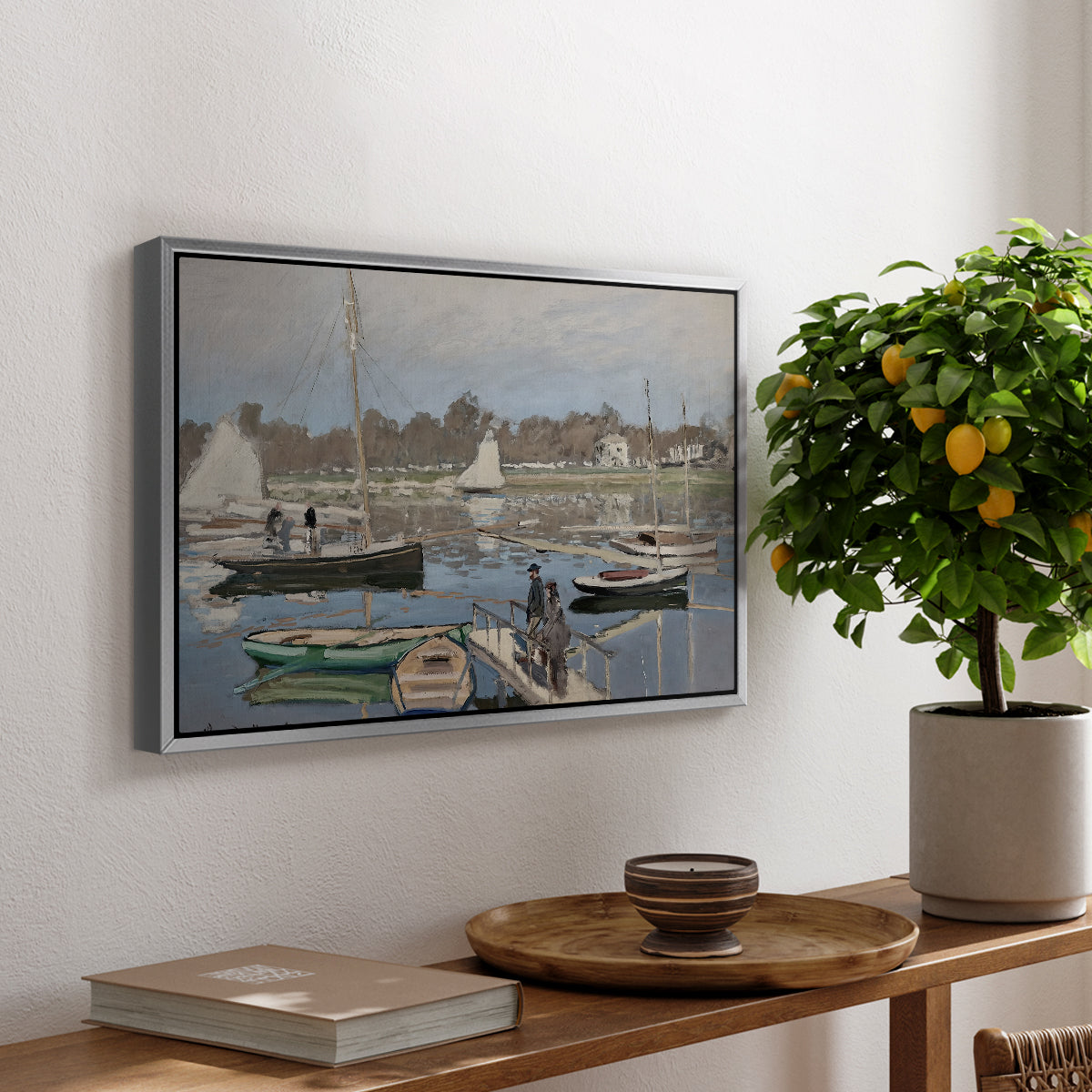 The Basin at Argenteuil, 1874 by Claude Monet, presented in a silver floater framed canvas featuring sailboats gathered in calm basin with reflections on water, displayed above a hallway console table.