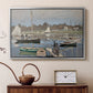 Silver floater framed canvas featuring a harbor basin filled with boats under soft sky, displayed above a cabinet in a soft-toned living room.
