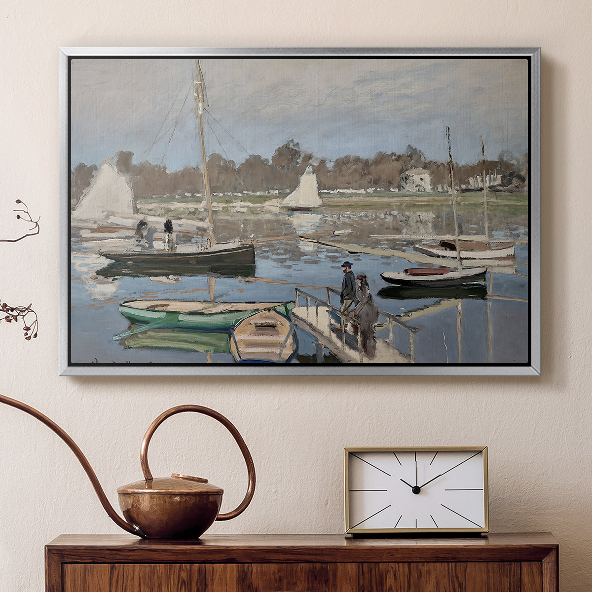 Silver floater framed canvas featuring a harbor basin filled with boats under soft sky, displayed above a cabinet in a soft-toned living room.