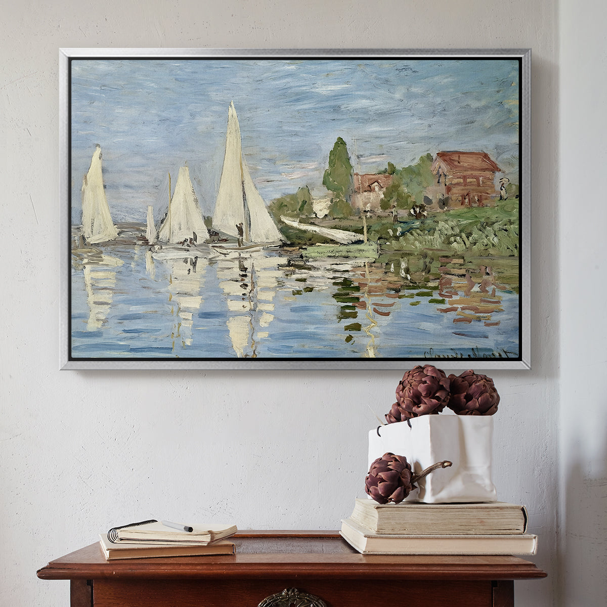 Silver floater framed canvas featuring Regatta at Argenteuil, 1872 by Claude Monet above an entryway table in a minimalist foyer.