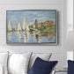 Regatta at Argenteuil, 1872 by Claude Monet displayed above a sofa in a living room in a silver floater frame, featuring a lively regatta scene with multiple boats and fluttering sails.
