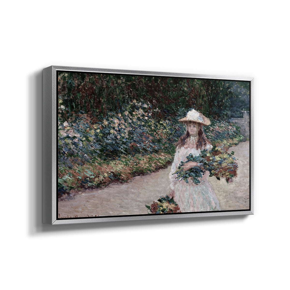 Angled view of Young Girl in the Garden at Giverny, 1888 by Claude Monet in a silver floater framed canvas.