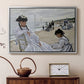 Silver floater framed canvas featuring a beach setting with people relaxing under umbrellas, displayed above a cabinet in a soft-toned living room.