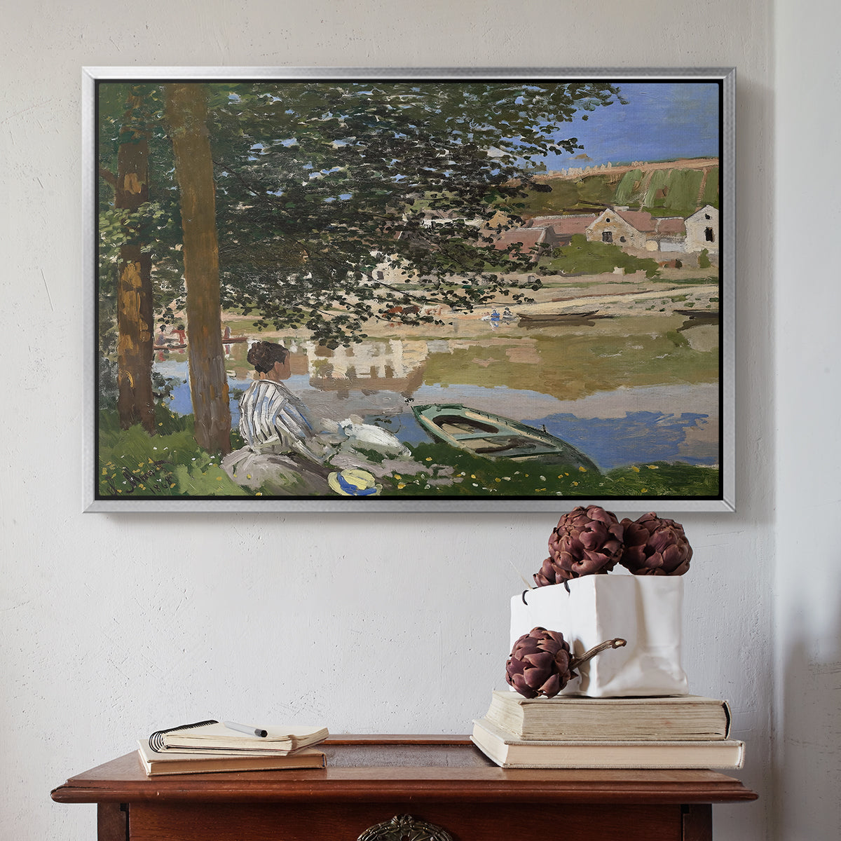 Silver floater framed canvas featuring On the Bank of the Seine, Bennecourt, 1868 by Claude Monet above an entryway table in a minimalist foyer.