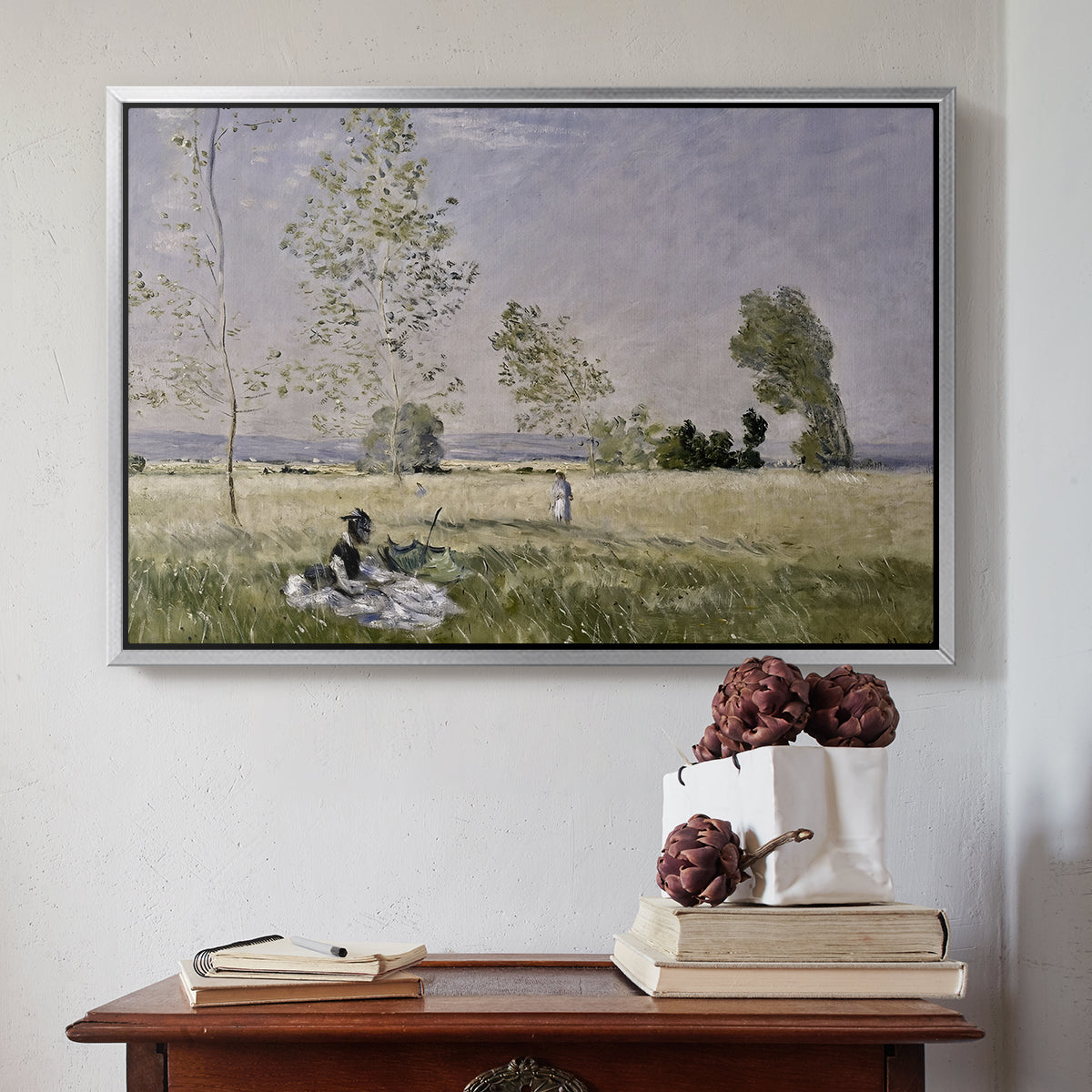 Silver floater framed canvas featuring Summer (L'ete), 1874 by Claude Monet above an entryway table in a minimalist foyer.