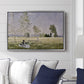 Summer (L'ete), 1874 by Claude Monet displayed above a sofa in a living room in a silver floater frame, featuring an impressionist countryside scene with figure resting in shade.