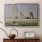 Silver floater framed canvas featuring a sunlit meadow with woman surrounded by greenery, displayed above a cabinet in a soft-toned living room.
