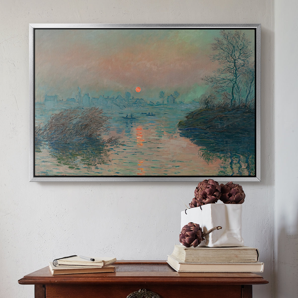 Silver floater framed canvas featuring Sunset on the Seine at Lavacourt, Winter Effect, 1880 by Claude Monet above an entryway table in a minimalist foyer.