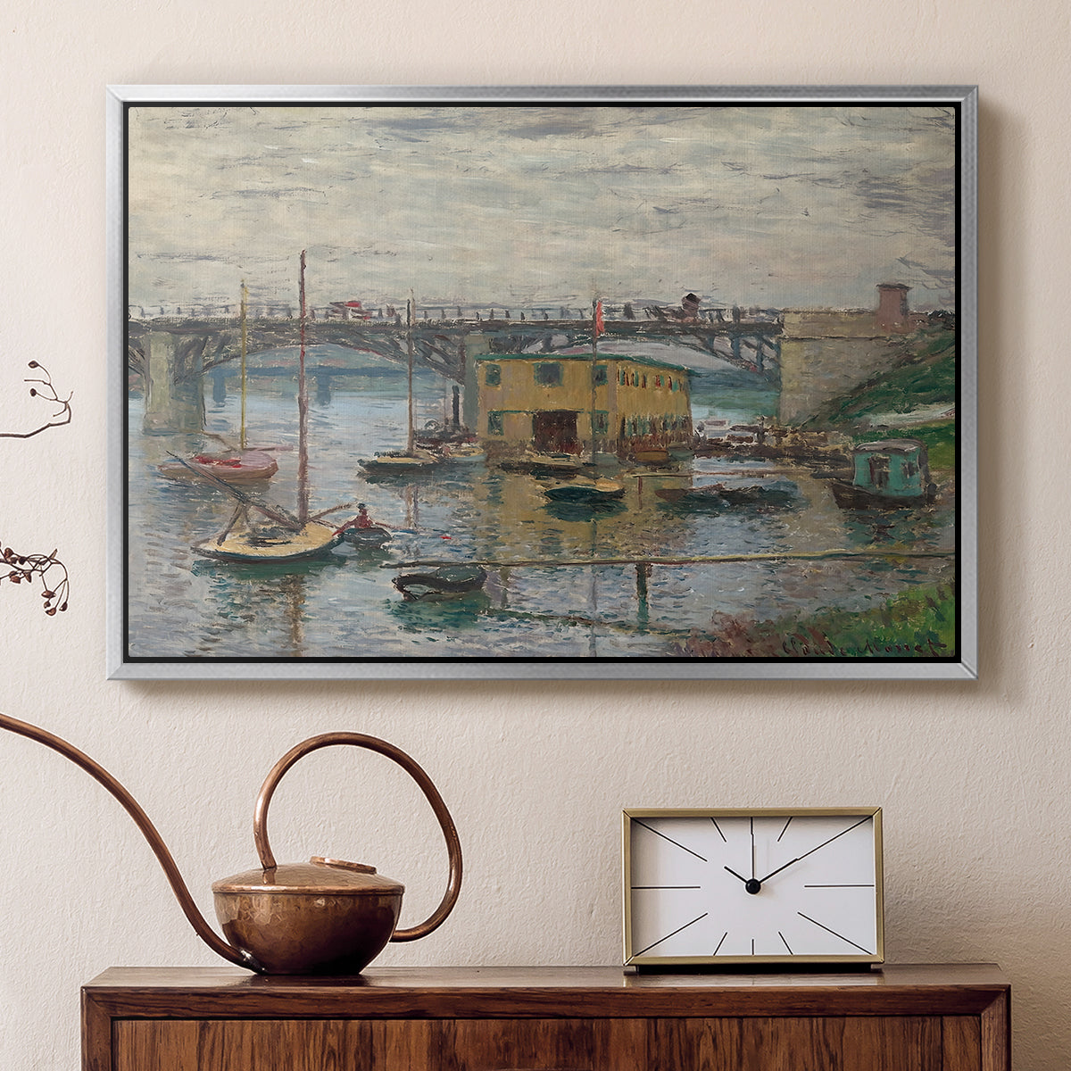 Silver floater framed canvas featuring a calm water scene with bridge fading into cloudy sky, displayed above a cabinet in a soft-toned living room.
