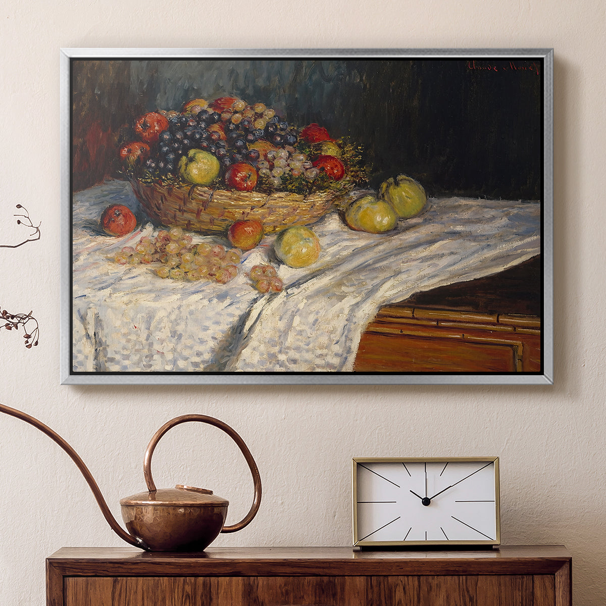 Silver floater framed canvas featuring a close-up of apples and grapes in warm tones, displayed above a cabinet in a soft-toned living room.