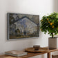 The Gare Saint-Lazare, 1877 by Claude Monet, presented in a silver floater framed canvas featuring a train station interior filled with steam and locomotives under iron structure, displayed above a hallway console table.