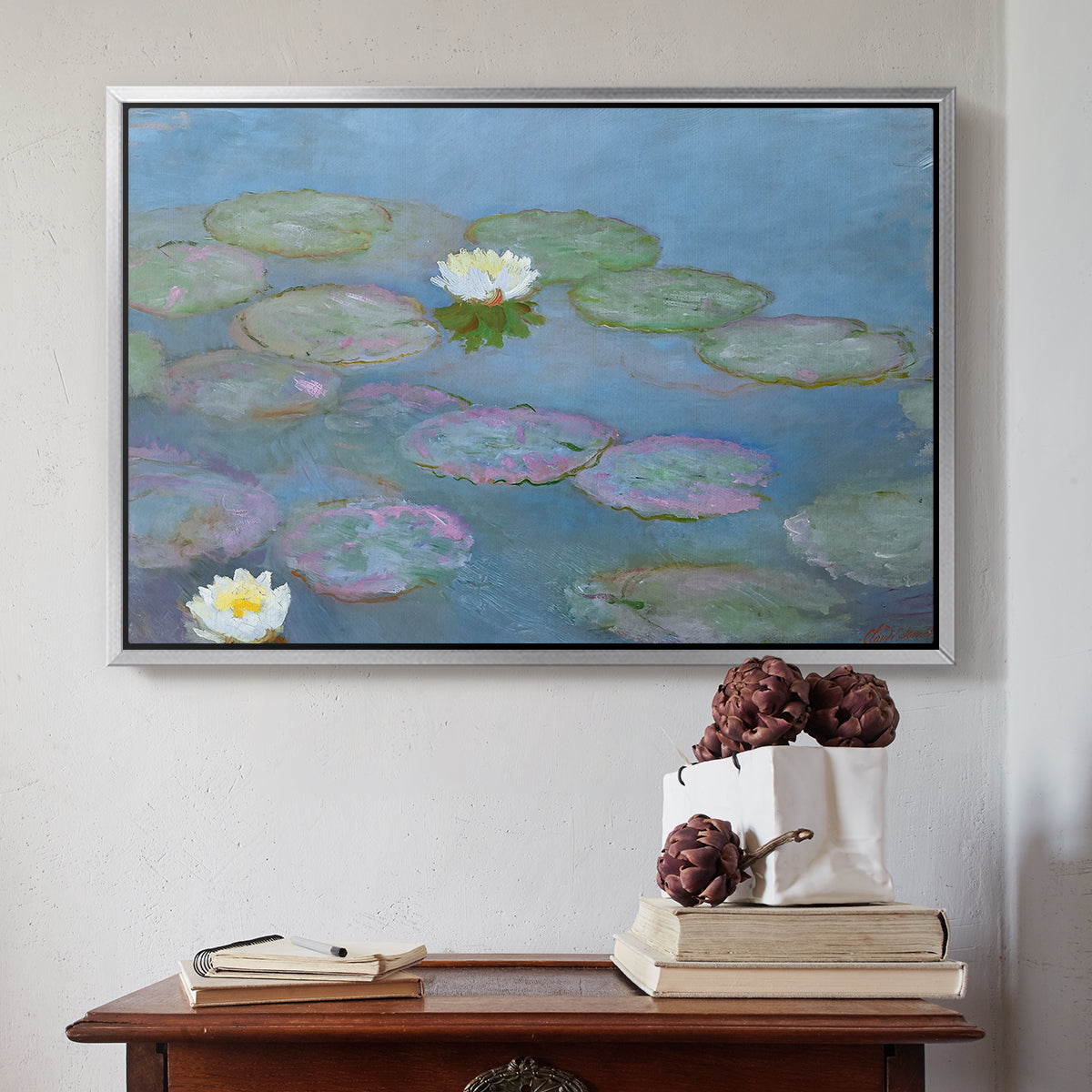 Silver floater framed canvas featuring Water Lilies (Nymphéas), 1897-1899 by Claude Monet above an entryway table in a minimalist foyer.