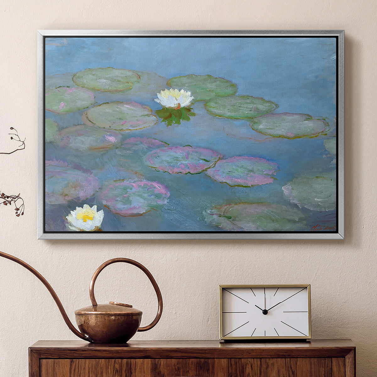 Silver floater framed canvas featuring a tranquil water surface covered with blooming lilies, displayed above a cabinet in a soft-toned living room.