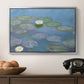 Water Lilies (Nymphéas), 1897-1899 by Claude Monet in a silver floater framed canvas displayed above a console table in a hallway, featuring a close-up of aquatic plants in still water.