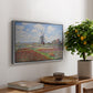 Tulip Fields with the Rijnsburg Windmill, 1886 by Claude Monet, presented in a silver floater framed canvas featuring colorful rows of tulip fields leading toward distant windmill, displayed above a hallway console table.