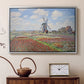 Silver floater framed canvas featuring an impressionist field of blooming tulips under bright sky, displayed above a cabinet in a soft-toned living room.