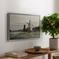 Windmill at Zaandam, 1871 by Claude Monet, presented in a silver floater framed canvas featuring a single windmill beside water with surrounding buildings and sky, displayed above a hallway console table.