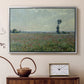 Silver floater framed canvas featuring a rural meadow with scattered poppies and soft horizon, displayed above a cabinet in a soft-toned living room.