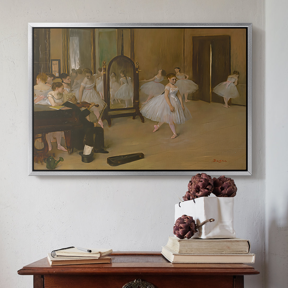 Silver floater framed canvas featuring The Dancing Class, c. 1870 by Edgar Degas above an entryway table in a minimalist foyer.