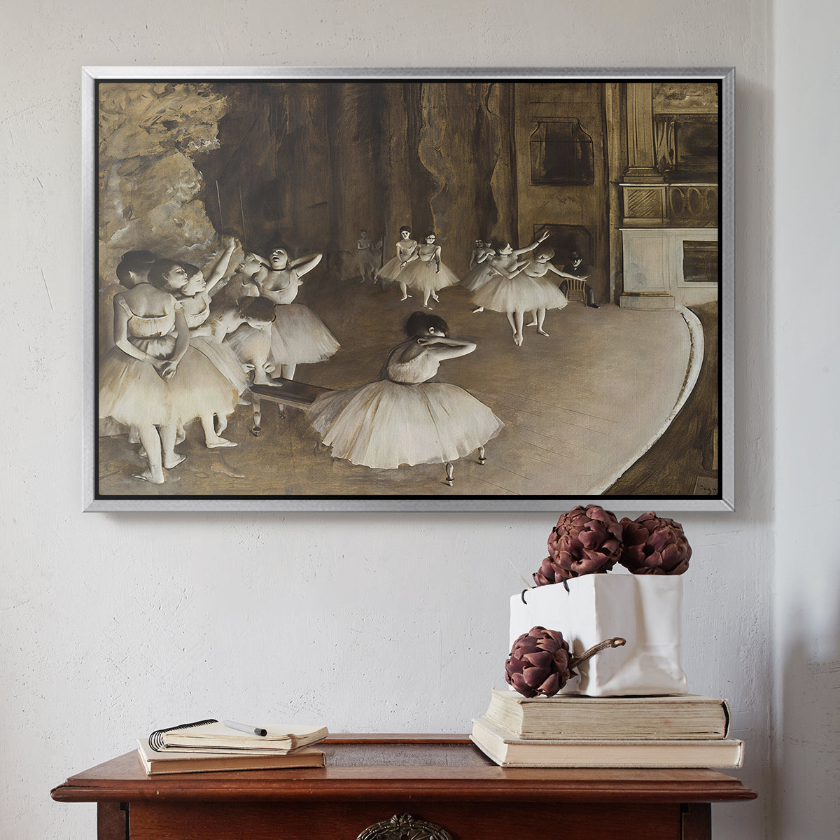 Silver floater framed canvas featuring The Rehearsal of the Ballet Onstage, 1874 by Edgar Degas above an entryway table in a minimalist foyer.