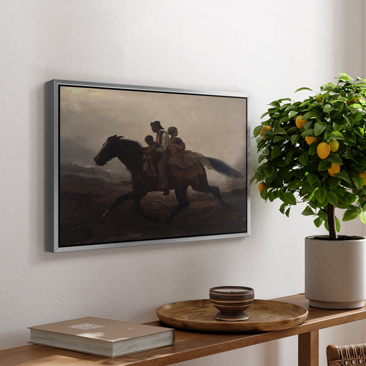 A Ride for Liberty – The Fugitive Slaves, c. 1862 by Eastman Johnson, presented in a silver floater framed canvas featuring a family riding horseback through night escaping across landscape, displayed above a hallway console table.