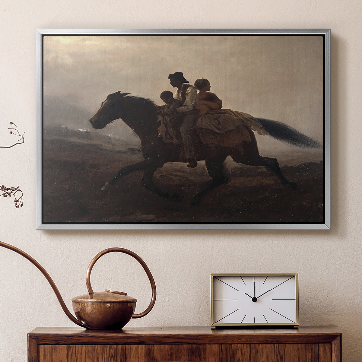 Silver floater framed canvas featuring a narrative painting of escape and urgency across rugged terrain, displayed above a cabinet in a soft-toned living room.