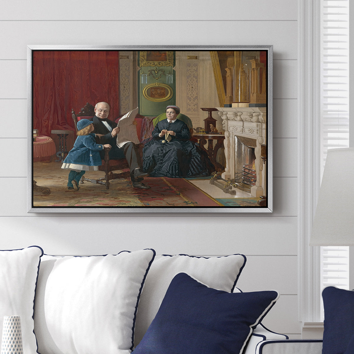 The Brown Family, 1869 by Eastman Johnson displayed above a sofa in a living room in a silver floater frame, featuring a domestic portrait of group gathered in modest home setting.