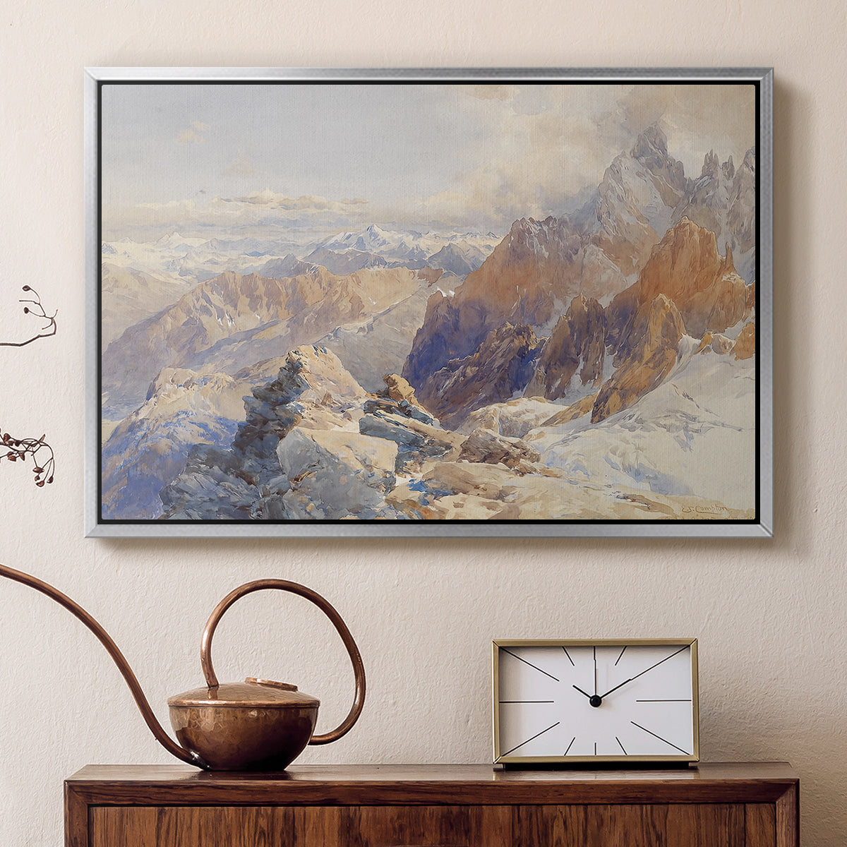 Silver floater framed canvas featuring a panoramic alpine view with snow and rocky cliffs, displayed above a cabinet in a soft-toned living room.