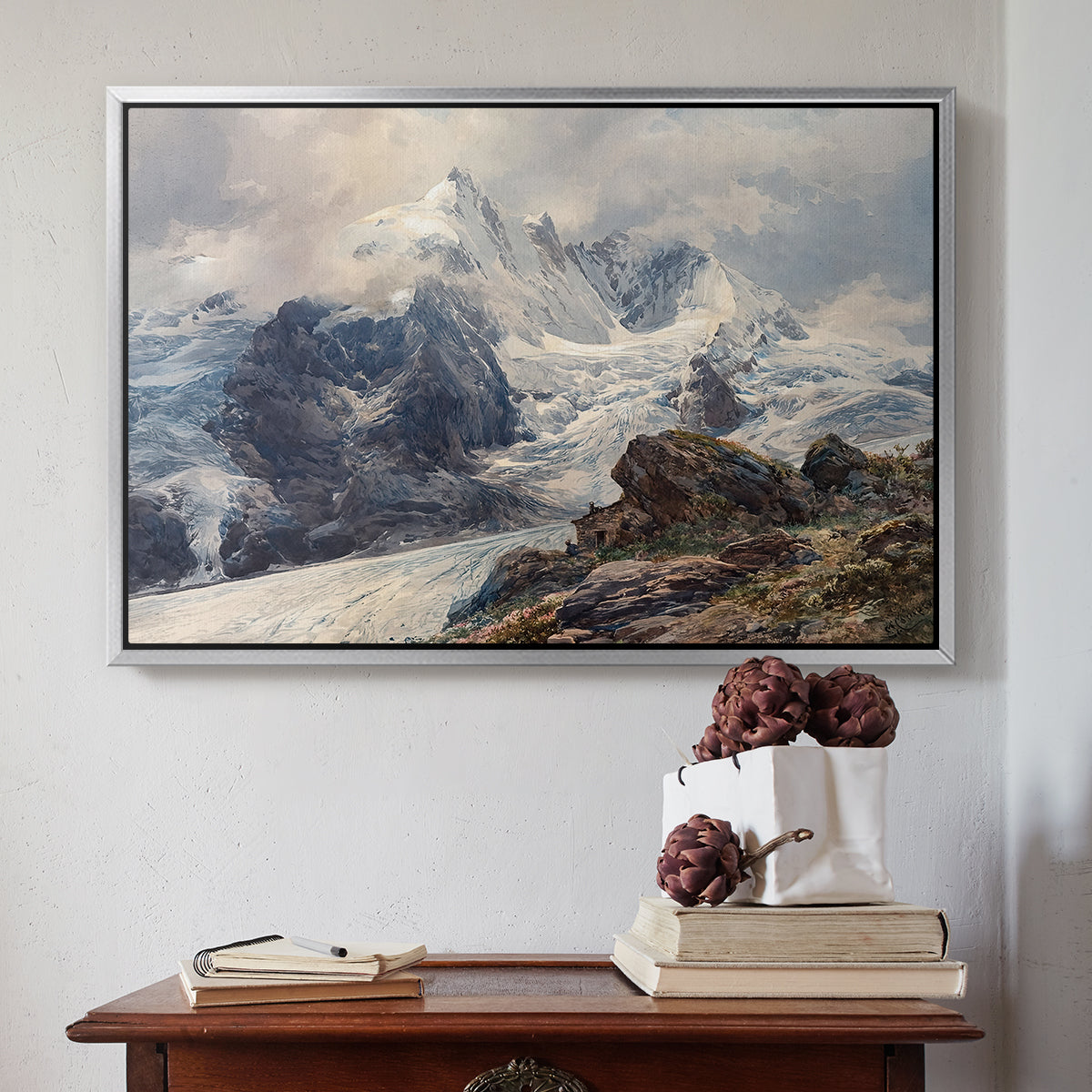 Silver floater framed canvas featuring The Grossglockner, 1880 by Edward Theodore Compton above an entryway table in a minimalist foyer.