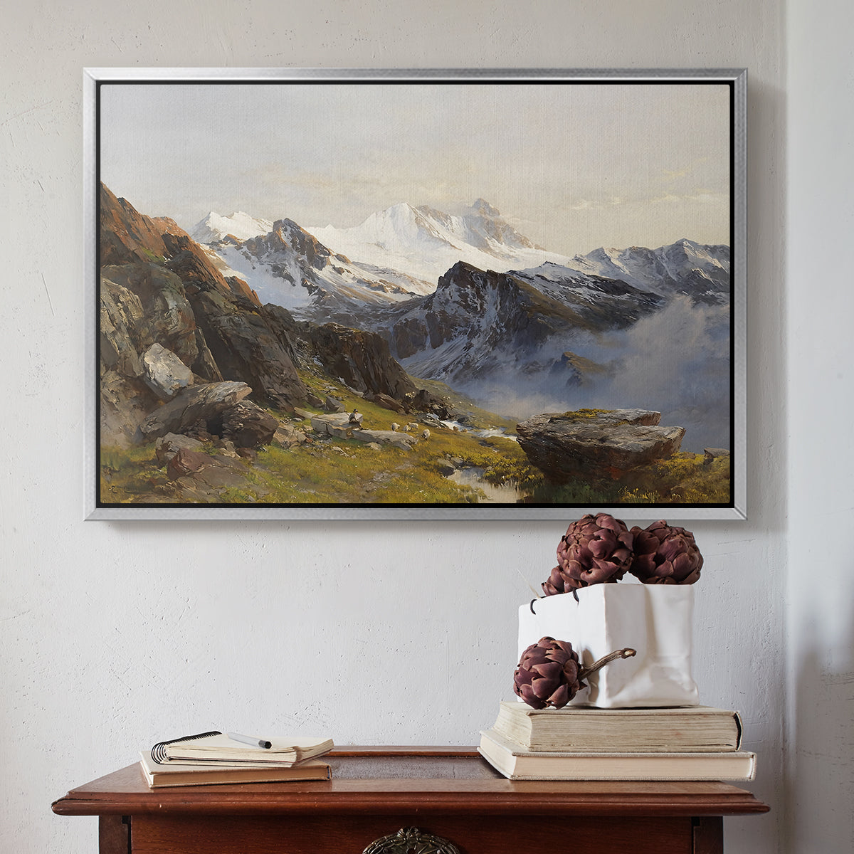 Silver floater framed canvas featuring The Großglockner from the Prager Hut, 1890 by Edward Theodore Compton above an entryway table in a minimalist foyer.
