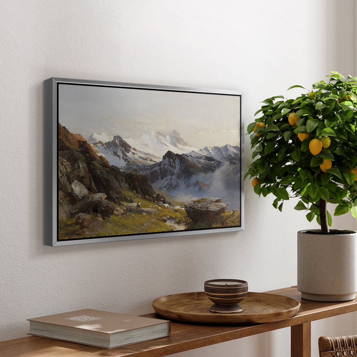 The Großglockner from the Prager Hut, 1890 by Edward Theodore Compton, presented in a silver floater framed canvas featuring a view of Großglockner peak from alpine hut overlooking valley, displayed above a hallway console table.