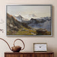 Silver floater framed canvas featuring an alpine vista with towering peak and foreground terrain, displayed above a cabinet in a soft-toned living room.