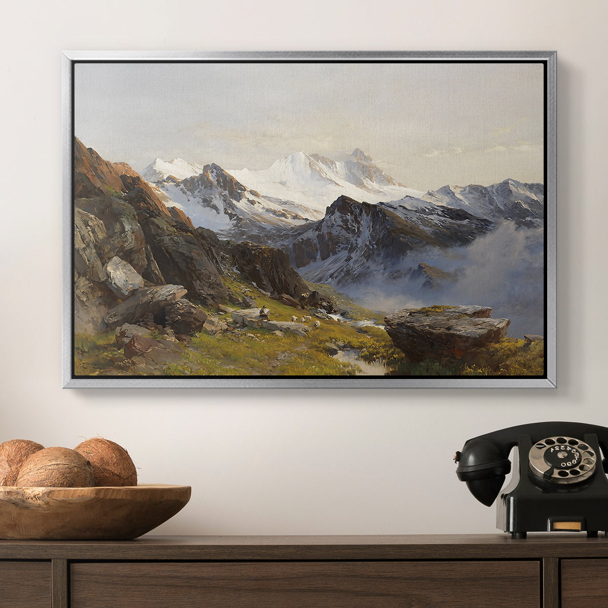 The Großglockner from the Prager Hut, 1890 by Edward Theodore Compton in a silver floater framed canvas displayed above a console table in a hallway, featuring a scenic mountain view with dramatic elevation and depth.