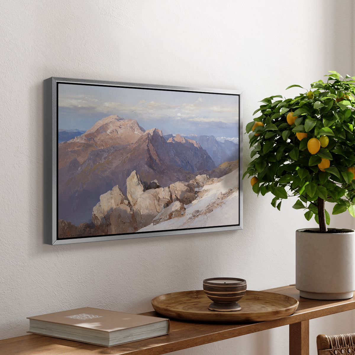 Hoher Göll from Watzmann-Hocheck, 1919 by Edward Theodore Compton, presented in a silver floater framed canvas featuring a distant mountain peak viewed from elevated ridge with sweeping landscape, displayed above a hallway console table.