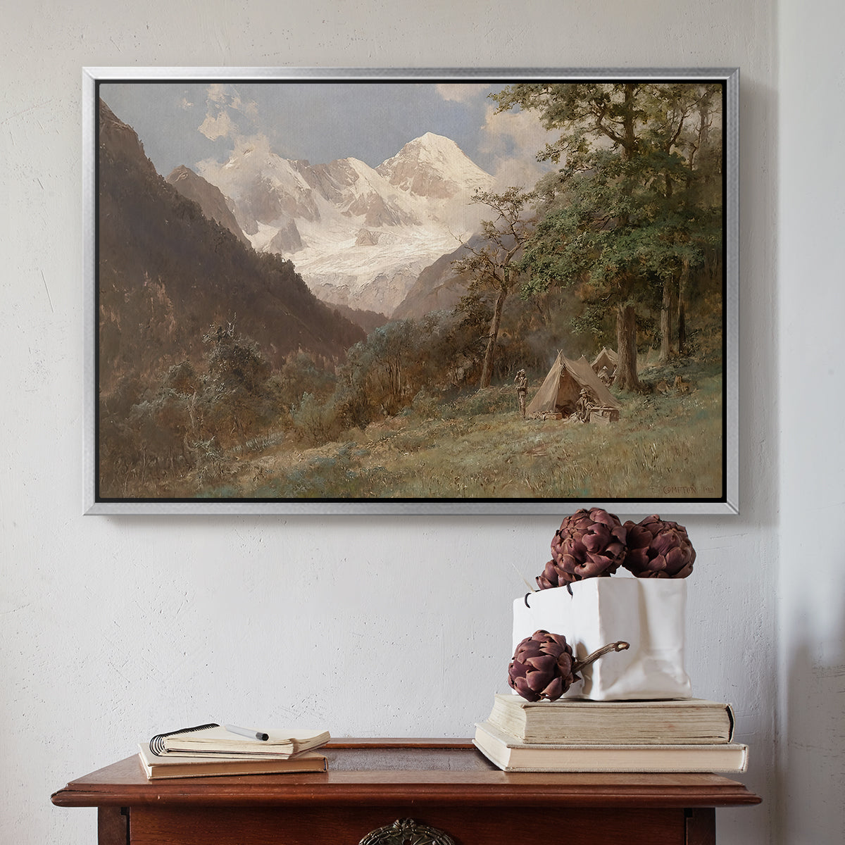 Silver floater framed canvas featuring Landscape in the Caucasus, c. 1921 by Edward Theodore Compton above an entryway table in a minimalist foyer.