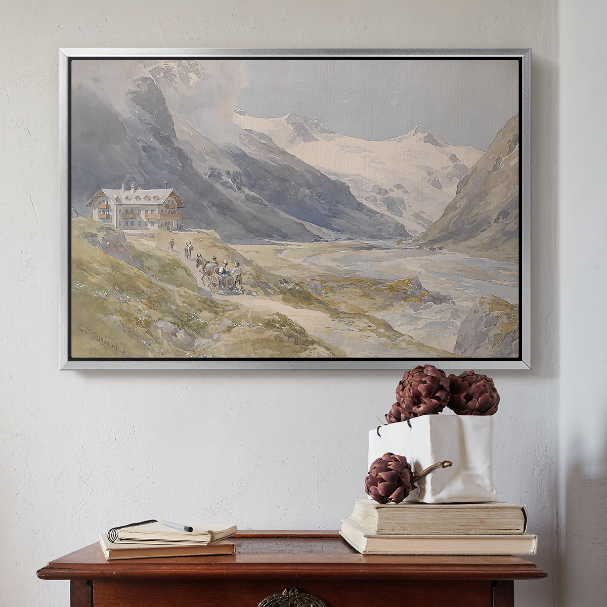 Silver floater framed canvas featuring Shepherds (Pasterze), c. 1921 by Edward Theodore Compton above an entryway table in a minimalist foyer.
