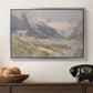 Shepherds (Pasterze), c. 1921 by Edward Theodore Compton in a silver floater framed canvas displayed above a console table in a hallway, featuring a natural landscape with human presence among mountains.