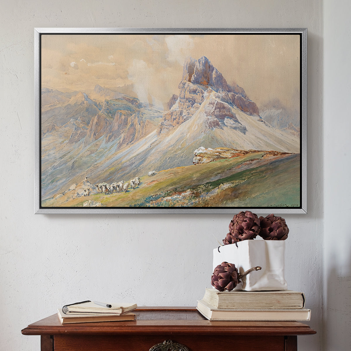 Silver floater framed canvas featuring From the Dolomites, 1904 by Edward Theodore Compton above an entryway table in a minimalist foyer.