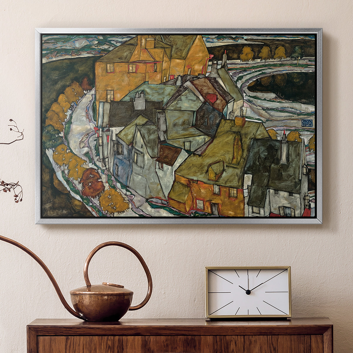 Silver floater framed canvas featuring an expressionist depiction of island town with geometric forms, displayed above a cabinet in a soft-toned living room.