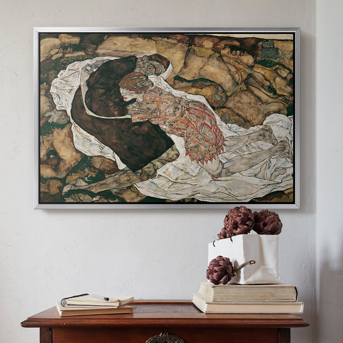 Silver floater framed canvas featuring Death and the Maiden, 1915 by Egon Schiele above an entryway table in a minimalist foyer.