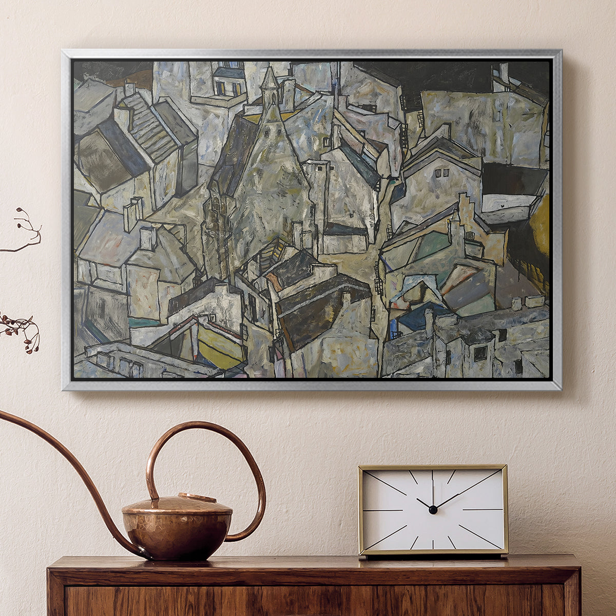 Silver floater framed canvas featuring an abstracted town view with angular rooftops and fragmented forms, displayed above a cabinet in a soft-toned living room.