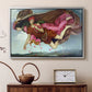 Silver floater framed canvas featuring a dreamlike scene with draped figures drifting across dark background, displayed above a cabinet in a soft-toned living room.